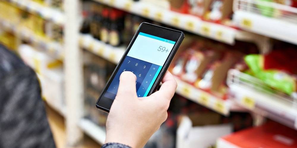 Calculator on a smartphone screen in the hand of women customers